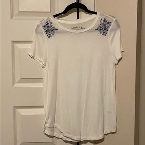 White tee with floral accent